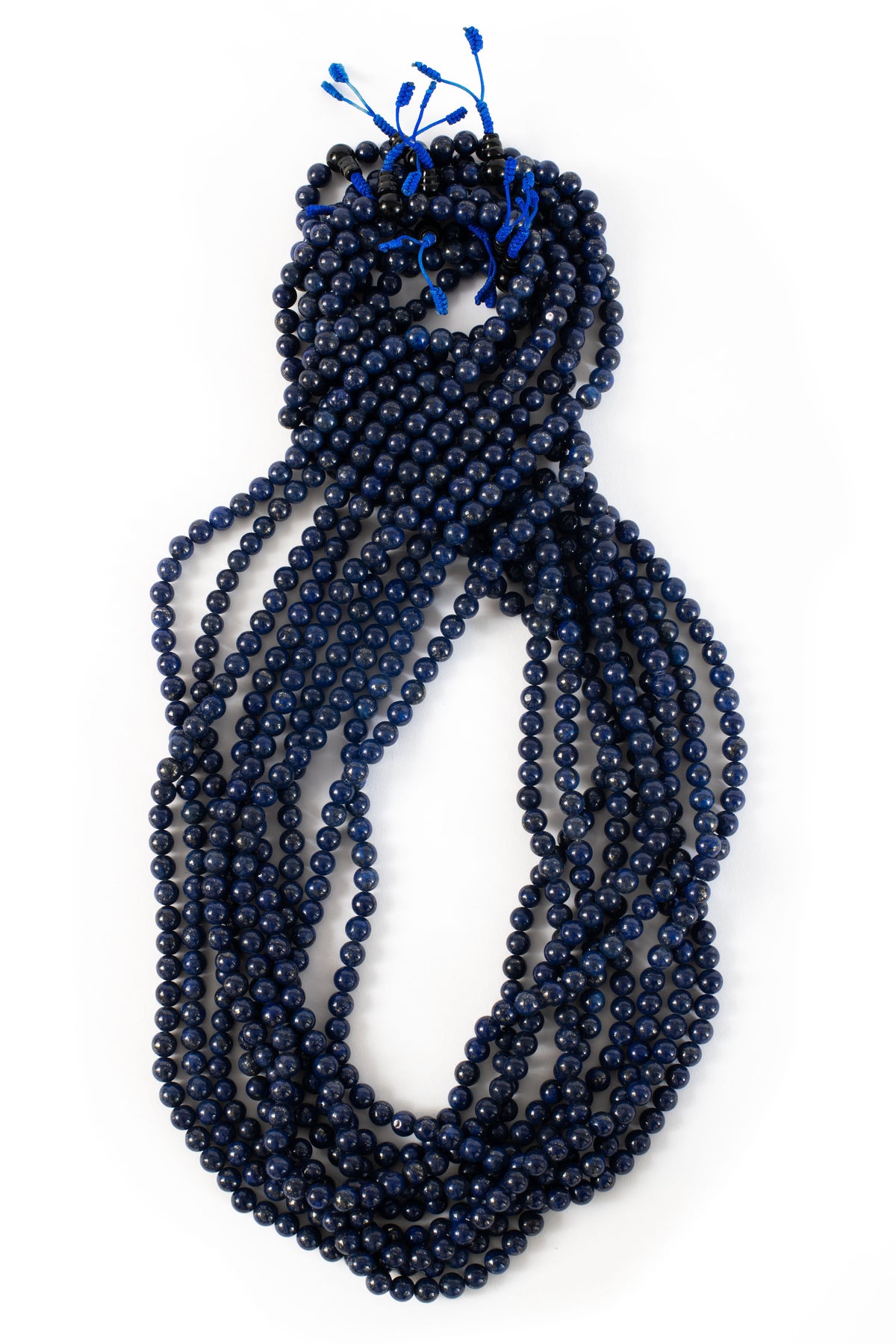 Lapis beaded malas on white background