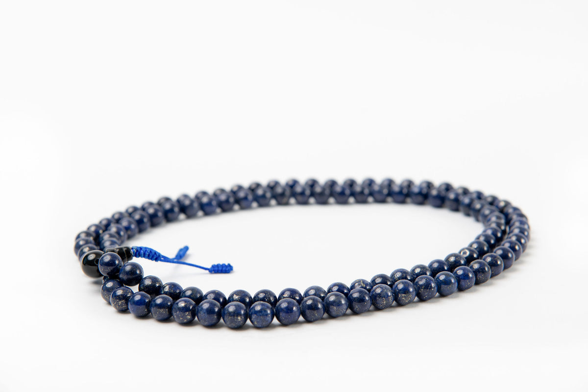 Lapis beaded mala on white background